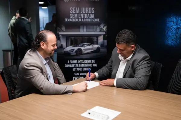 Client signing their NWX Consorcio agreement at the office