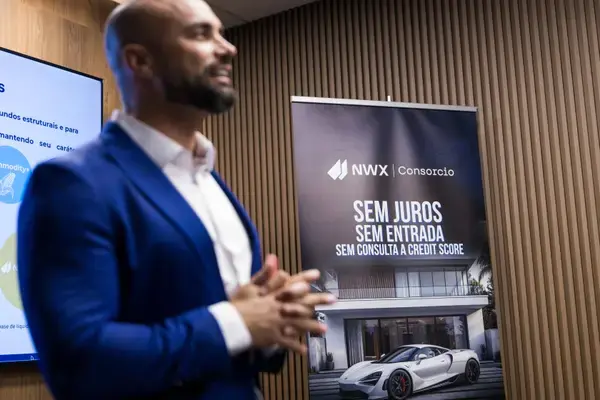 NWX Consorcio speaker next to the branded event banner